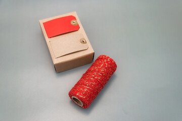  red ribbon and name tags for wrapping New Year's gifts. cotton red ribbon with golden inserts. place for text, christmas atmosphere, new year, gifts, family, holiday