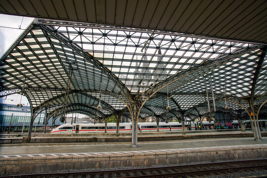 Main railway station of Cologne ans speedy train in Distance (ICY) and people
