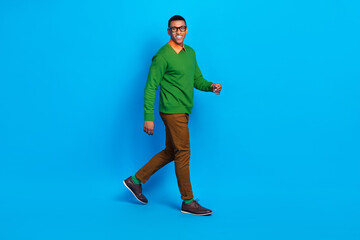 Full size profile photo of young satisfied positive guy wear nice shoes classy gentleman outfit walking his office isolated on bright blue color background