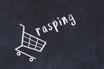 Chalk drawing of shopping cart and word rasping on black chalboard. Concept of globalization and mass consuming
