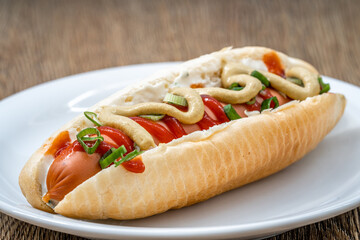 hot dog with mustard ketchup and spring onion