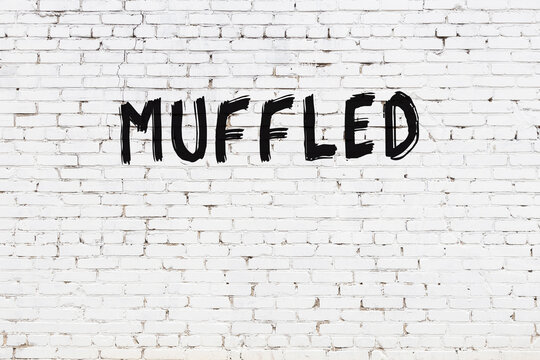 White wall with black paint inscription muffled on it