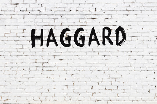 Inscription haggard painted on white brick wall
