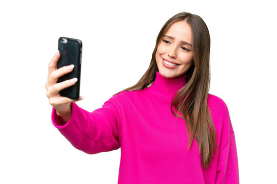Young beautiful caucasian woman over isolated background making a selfie with mobile phone