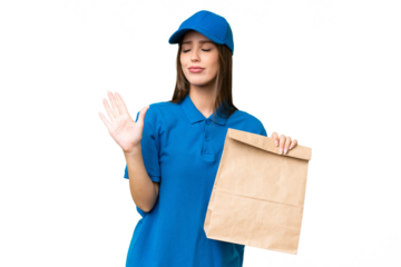 Young beautiful caucasian woman taking a bag of takeaway food over isolated background making stop gesture and disappointed