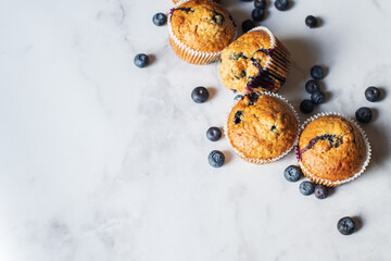 Blueberry muffins on a white marble background. - 548052719