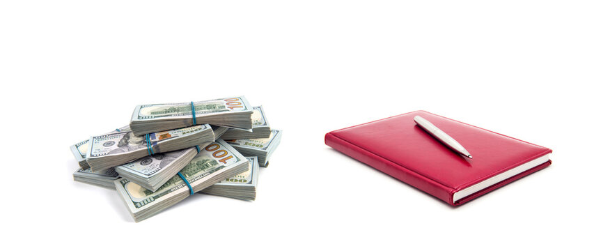 American dollars and red notebook on a white background