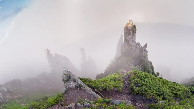 Magical Glory in mountains Spitz, Ukrainian Carpathian Mountains. A glory (halo) is an optical phenomenon. High stone ledges in mountains, mystical and scary mountains in fog. 2 in 1.