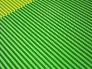 The corrugated surface is multicolored with parallel lines as a background black blue orange crimson pink light green orange and purple