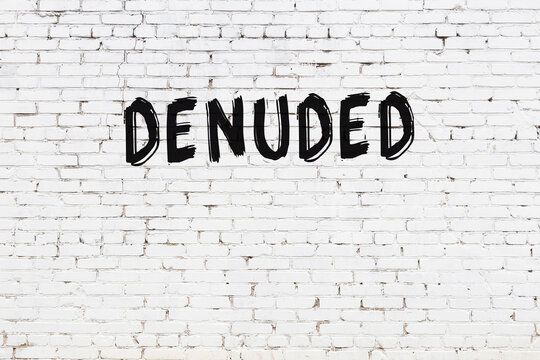 White wall with black paint inscription denuded on it