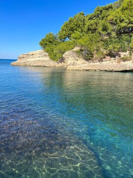 Rocky island in the turquoise sea with clear water at summer.