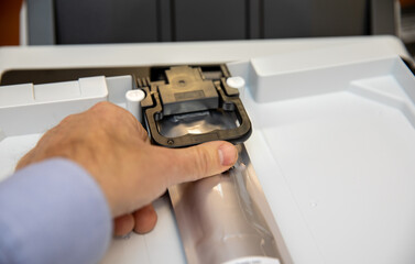 Installing an ink container in an inkjet printer.