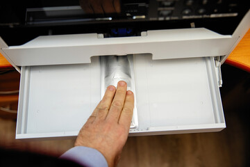 Installing an ink container in an inkjet printer.