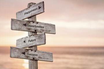 happiness opportunities future success text written on wooden signpost outdoors at the beach during sunset
