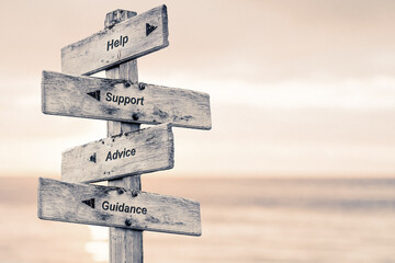 help support advice guidance text written on wooden signpost outdoors at the beach during sunset