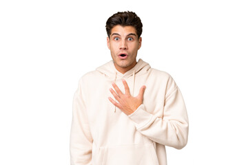 Young caucasian handsome man over isolated background surprised and shocked while looking right