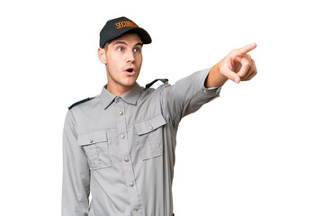 Young security man over isolated background pointing away