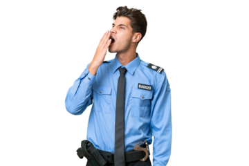 Young police man over isolated background yawning and covering wide open mouth with hand