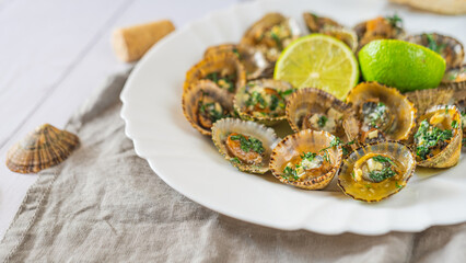 Patella, Limpets with lime on white plate - traditional seafood of Tenerife and Madeira Islands.