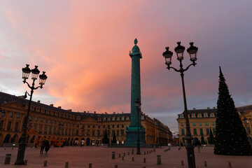 Fototapeta na wymiar Vendome column with statue of Napoleon Bonaparte, on the Place Vendome decorated for Christmas at sunrise , Paris, France.