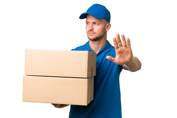 Delivery caucasian man over isolated background making stop gesture and disappointed