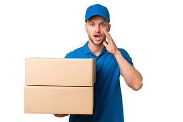 Delivery caucasian man over isolated background with surprise and shocked facial expression