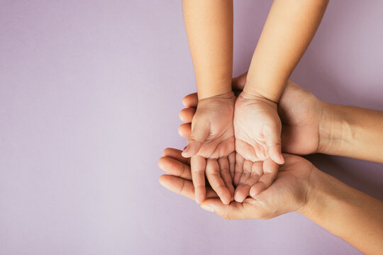 Top view parents and little kid holding empty hands together studio shot isolated on pink background, family home, hands children on adult mother hand, help support, parents family day concept