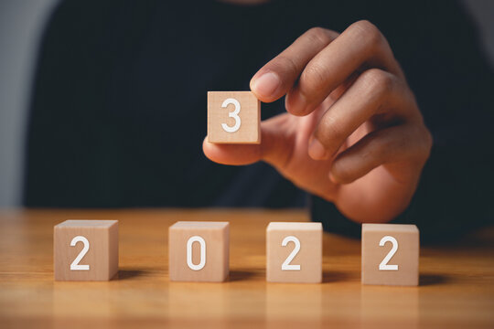 Happy New Year 2023. Happy businessman hand holding number 3 on wooden block to put replace or change previous year 2022, Business risk management, solution, Resolution, strategy, goal