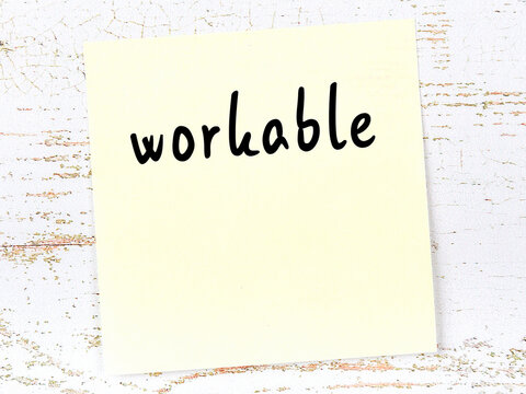 Yellow sheet of paper with word workable. Reminder concept