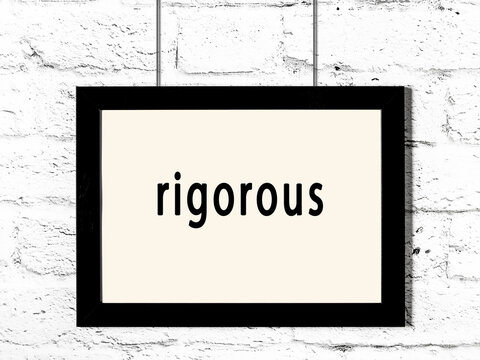 Black frame hanging on white brick wall with inscription rigorous