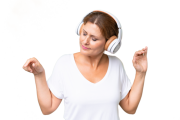 Middle-aged caucasian woman over isolated background listening music and dancing