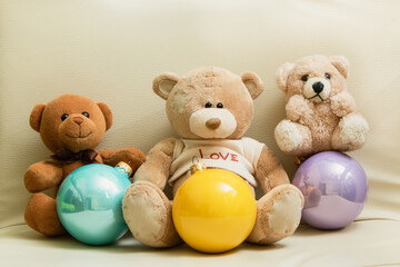 Teddy bears with Christmas New Year balls. Christmas holidays and gifts. Stuffed Toys