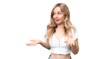Fototapeta na wymiar Young English woman over isolated background with surprise expression while looking side