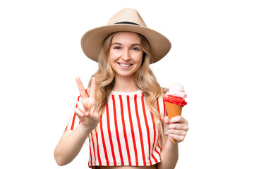 Young English woman with a cornet ice cream over isolated background smiling and showing victory...