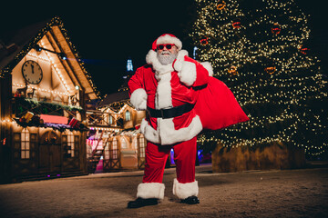 Full length photo of big santa saint nicholas hold carry presents travel new present give miracle enjoying night eve magic time outdoors