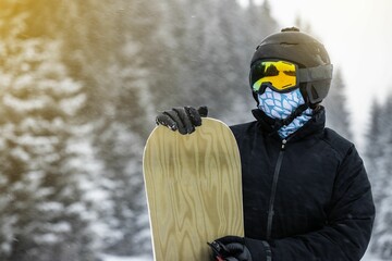 Young girl snowboarder holding her snowboard in the mountains.