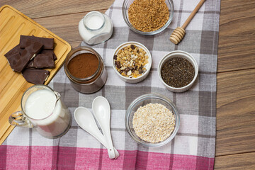 Bowl of chocolate granola with milk and other ingredients
