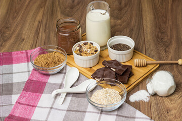 Bowl of chocolate granola with milk and other ingredients