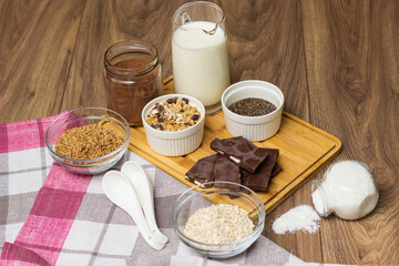 Bowl of chocolate granola with milk and other ingredients