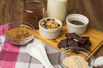 Bowl of chocolate granola with milk and other ingredients