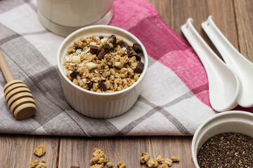 Bowl of chocolate granola with milk and other ingredients