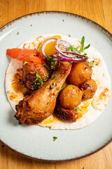 chicken with baked potato and vegetables