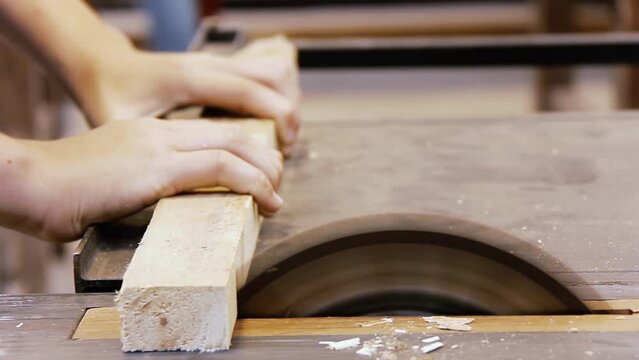 Carpentry Workshop Training School, Hands of a Young Student Using Bench Saw in Carpentry Class. Close Up. 4K Resolution.