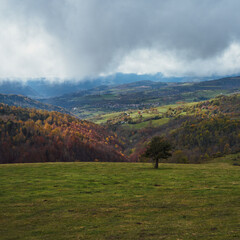 Beautiful view of rocky mountains with plants in Montserrat, Catalonia, Spain against a cloudy sky