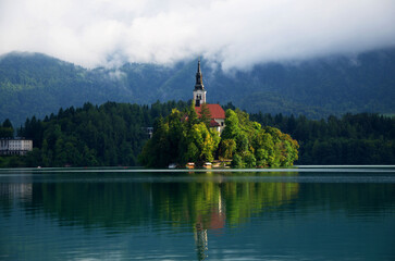Fototapeta na wymiar Bled, Slovenia - aerial view of the beautiful pilgrimage church of the Assumption of Mary on a small island in Lake Bledd