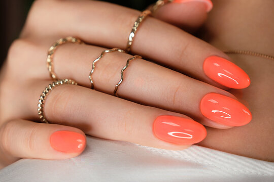 Bright neon manicure on female hands with accessories. Nail design.