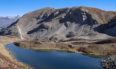 View of Lac de l'Oule mountain lake (2,425 m), beneath Col de l'Oule (2,546 m), located near Col de Granon (2, 413) in rhe Hautes-Alpes department, Briancon, France