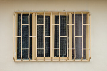 Window Divided into Four Light Yellow Sections with White Bars