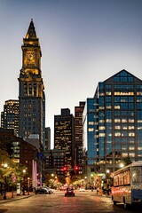 Beautiful vertical of Boston's street lights at night and cars driving on the skyline of skyscrapers