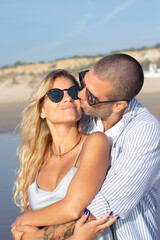 Obraz premium Portrait of tender Caucasian couple at beach. Husband and wife hugging, travelling in hot country. Portrait, vacation, beauty, relationship concept